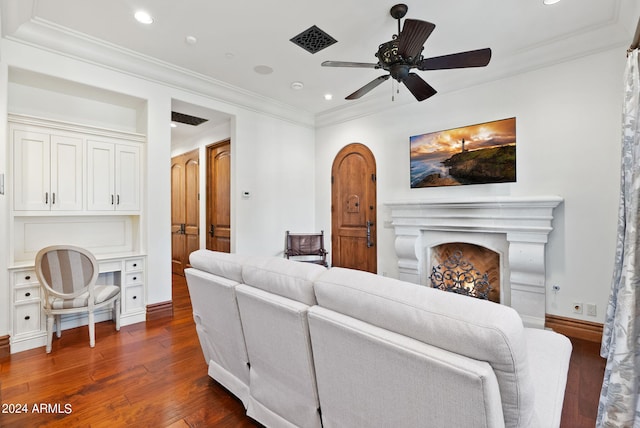 living room featuring dark hardwood / wood-style flooring, ceiling fan, and crown molding