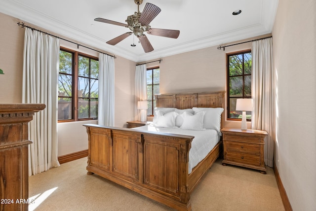 carpeted bedroom featuring ceiling fan and crown molding