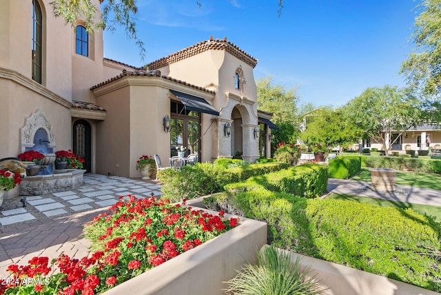 view of home's community with a lawn and a patio