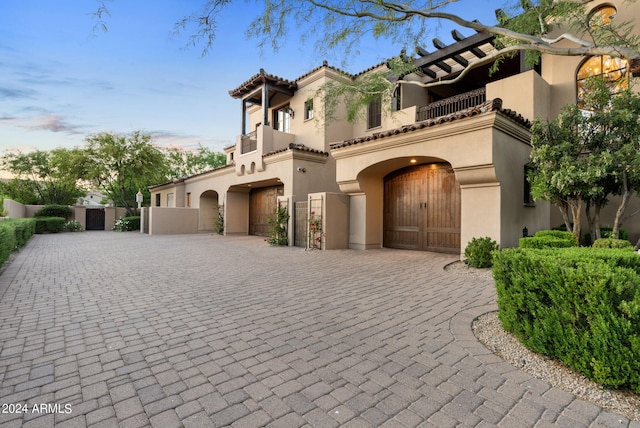 mediterranean / spanish-style home with a balcony