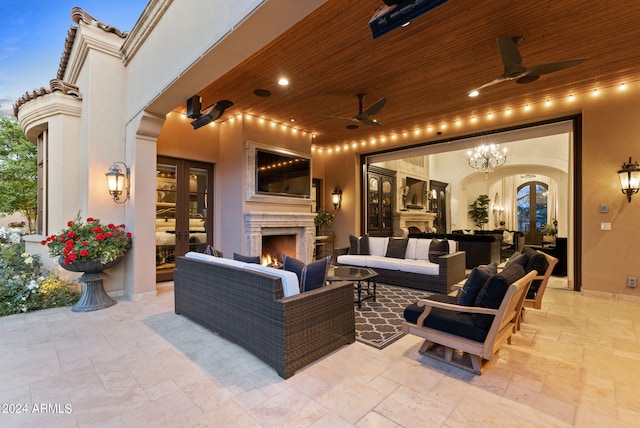 view of patio featuring an outdoor living space with a fireplace, french doors, and ceiling fan