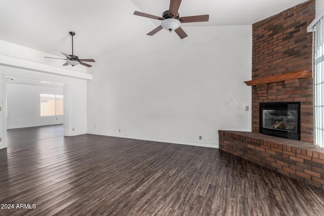 unfurnished living room with ceiling fan, dark hardwood / wood-style flooring, a fireplace, and vaulted ceiling