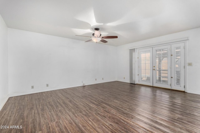 empty room featuring ceiling fan, dark wood-type flooring, and french doors