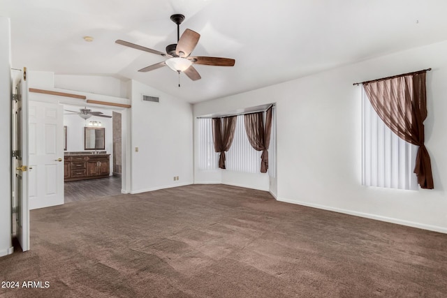 carpeted spare room featuring ceiling fan and vaulted ceiling