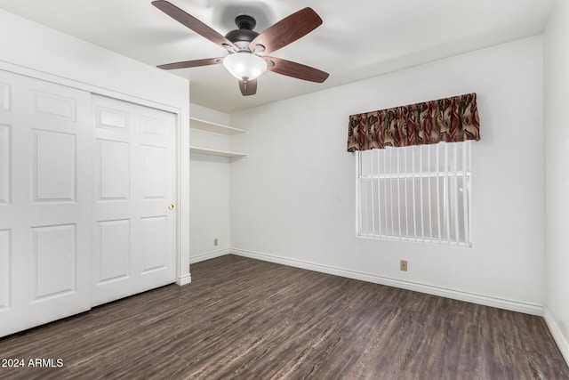 unfurnished bedroom featuring dark hardwood / wood-style floors, a closet, and ceiling fan