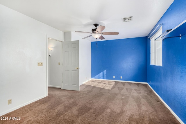 empty room featuring carpet flooring and ceiling fan