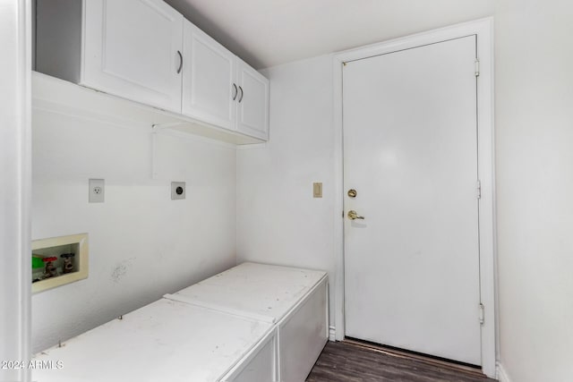 laundry area featuring electric dryer hookup, hookup for a washing machine, dark hardwood / wood-style flooring, and cabinets