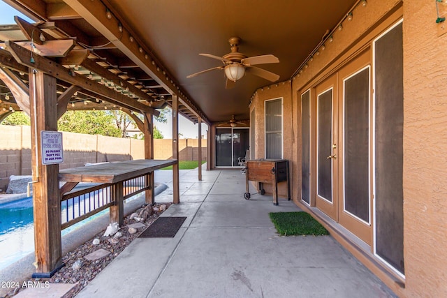 view of patio with a fenced in pool and ceiling fan