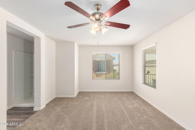 unfurnished room with ceiling fan and hardwood / wood-style flooring