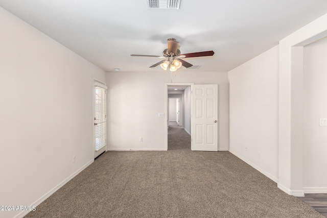 spare room with dark carpet and ceiling fan