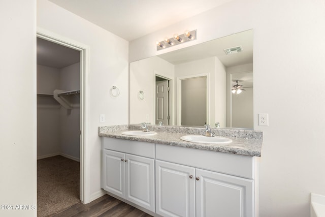 bathroom with vanity, ceiling fan, and hardwood / wood-style floors