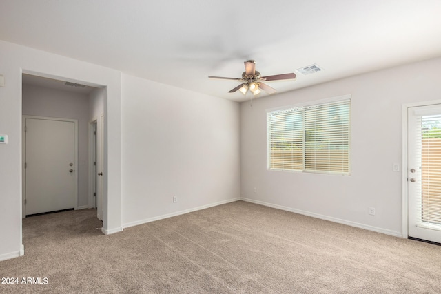 carpeted spare room featuring ceiling fan