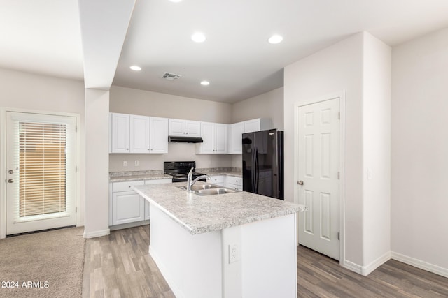 kitchen with a center island with sink, electric range oven, sink, black refrigerator, and white cabinets