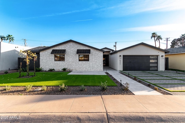 view of front of home featuring a garage and a front lawn