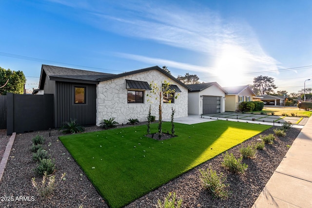 view of front of home with a front lawn and a garage