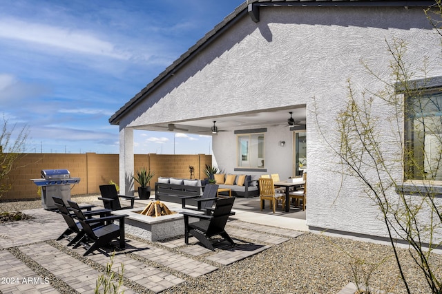 view of patio / terrace featuring an outdoor living space with a fire pit, ceiling fan, a fenced backyard, and grilling area