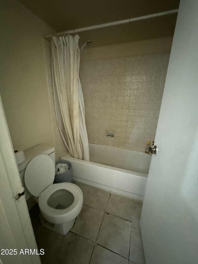 full bath featuring tile patterned floors, shower / tub combo, and toilet