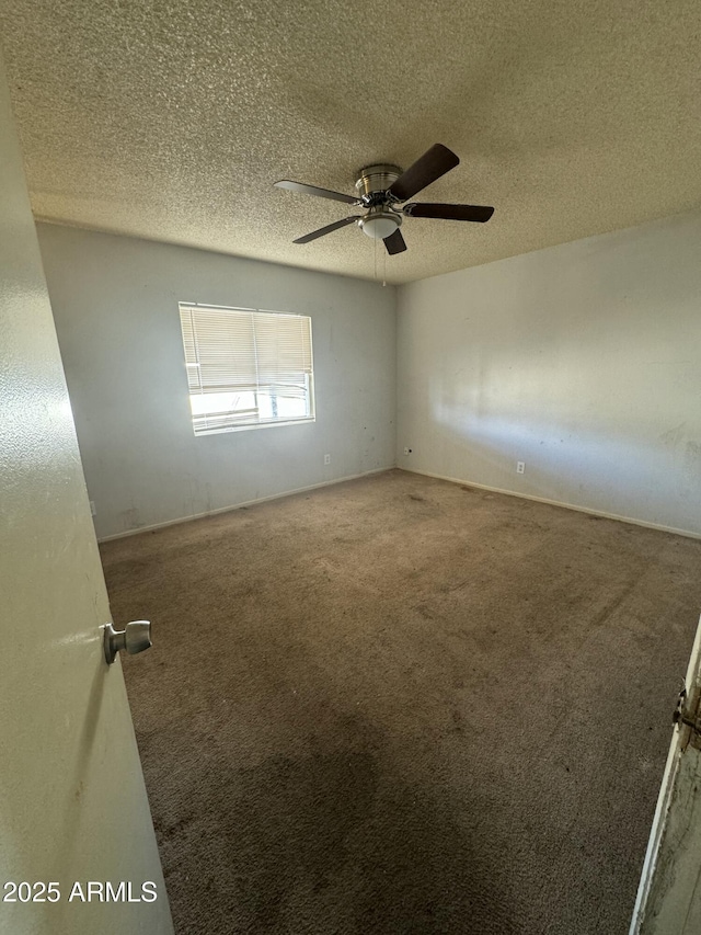 carpeted empty room with a textured ceiling and a ceiling fan