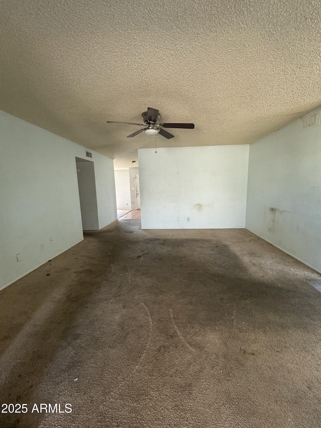 unfurnished room featuring carpet flooring, visible vents, and ceiling fan