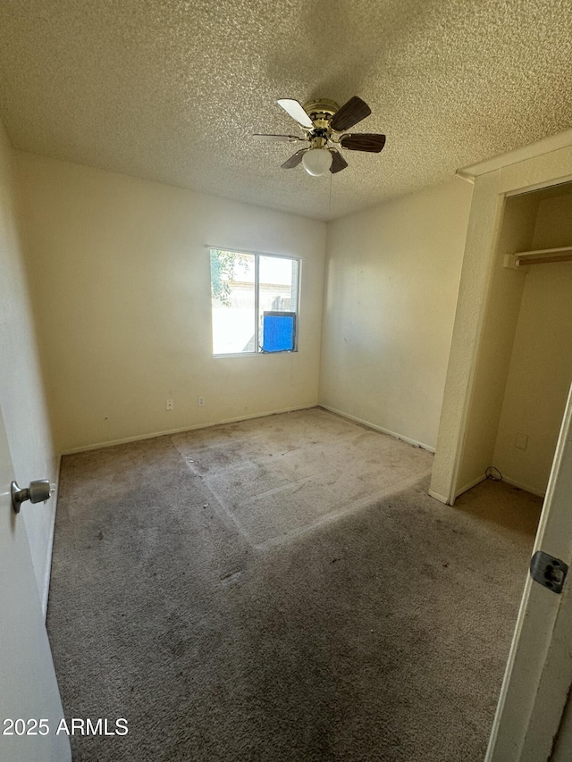 unfurnished bedroom with carpet, ceiling fan, and a textured ceiling