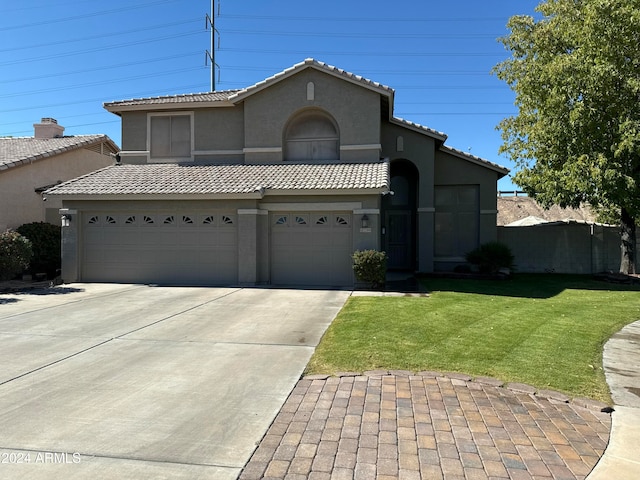 view of front of property featuring a garage and a front yard