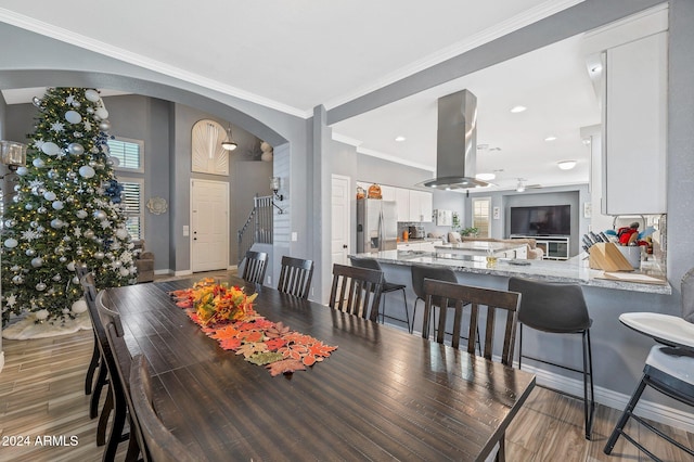 dining space featuring crown molding and wood-type flooring