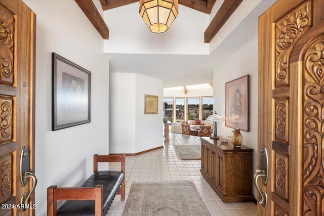 corridor featuring beam ceiling and light tile patterned floors