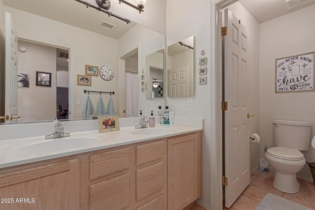 full bathroom with double vanity, tile patterned flooring, visible vents, and a sink