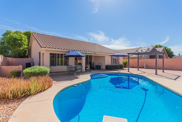 view of pool with a fenced in pool, fence, a pergola, and a patio