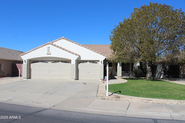 ranch-style home featuring stucco siding, concrete driveway, an attached garage, a front yard, and a tiled roof