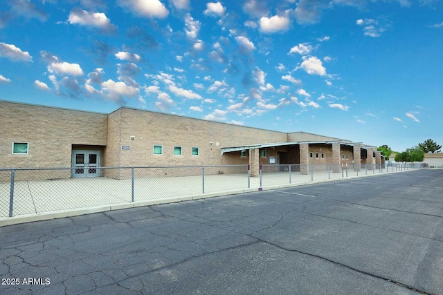 view of building exterior with fence