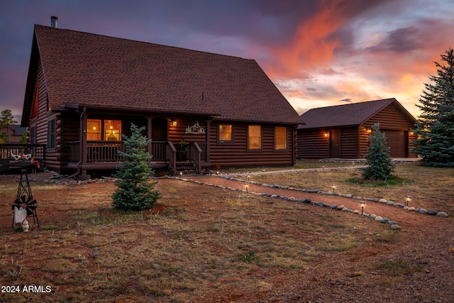 log-style house with covered porch