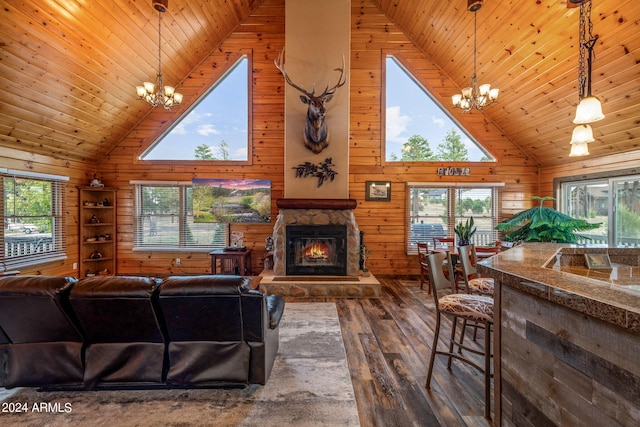 living room featuring wooden walls, plenty of natural light, hardwood / wood-style floors, and high vaulted ceiling