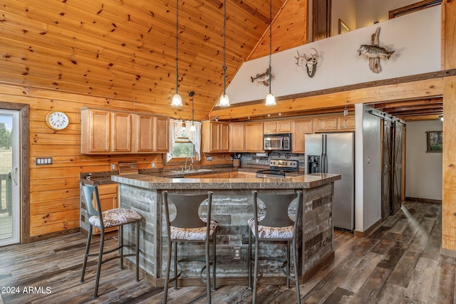 kitchen featuring wood walls, high vaulted ceiling, appliances with stainless steel finishes, dark hardwood / wood-style floors, and a breakfast bar area