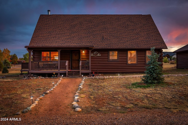 log-style house featuring a porch