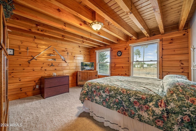 bedroom with light carpet, wood walls, and beam ceiling