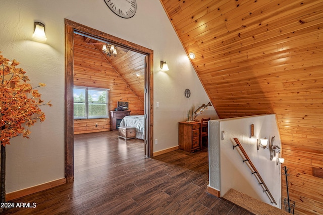 interior space with wood walls, wooden ceiling, dark wood-type flooring, and vaulted ceiling