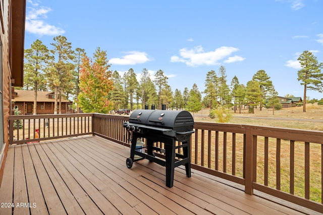 wooden deck featuring grilling area and a yard