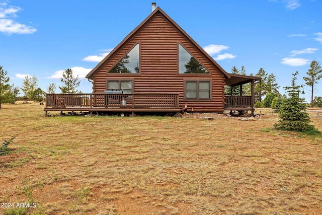 view of side of home featuring a deck and a yard