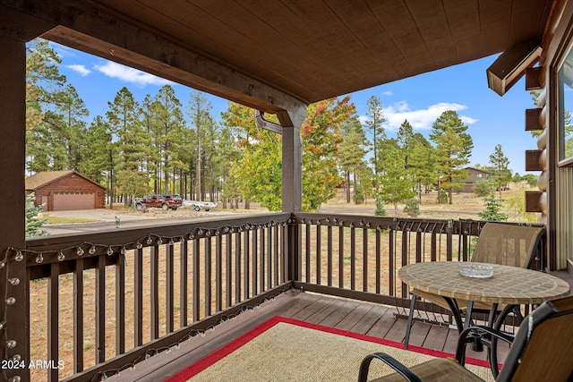 deck with a garage and an outbuilding