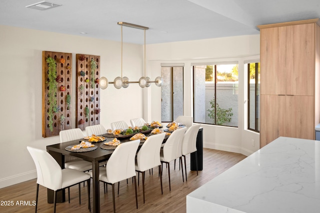 8001 E Voltaire Ave, Scottsdale, AZ 85260 - dining room with baseboards and light wood-style flooring