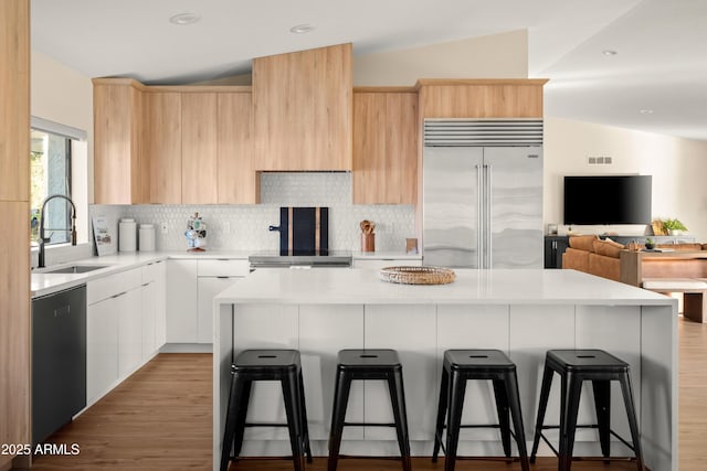8001 E Voltaire Ave, Scottsdale, AZ 85260 - kitchen featuring stainless steel built in refrigerator, modern cabinets, light brown cabinetry, a kitchen bar, and recessed lighting