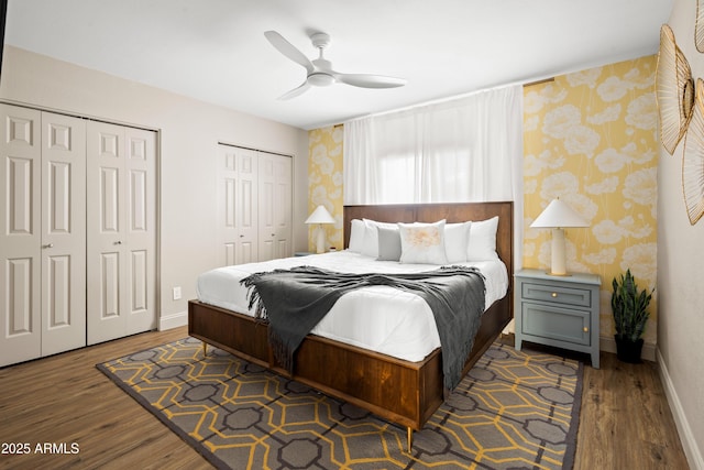 8001 E Voltaire Ave, Scottsdale, AZ 85260 - bedroom featuring two closets, wallpapered walls, wood finished floors, and a ceiling fan