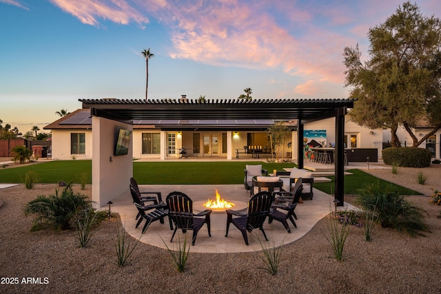 8001 E Voltaire Ave, Scottsdale, AZ 85260 - back of house at dusk featuring a fire pit, a patio, a yard, a pergola, and stucco siding
