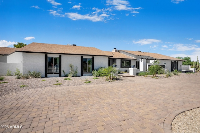 8001 E Voltaire Ave, Scottsdale, AZ 85260 - rear view of house featuring stucco siding and curved driveway
