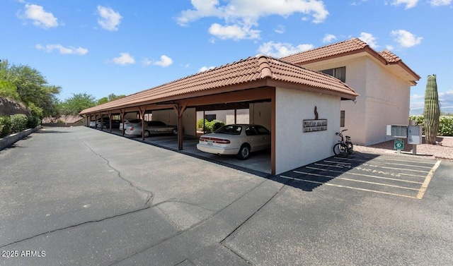 view of parking / parking lot featuring a carport