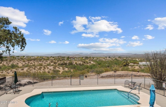 view of pool featuring a mountain view and a patio area