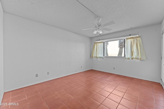 tiled empty room with a textured ceiling and ceiling fan