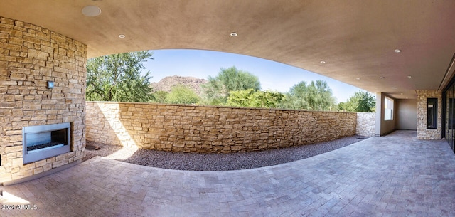 view of patio / terrace with an outdoor stone fireplace