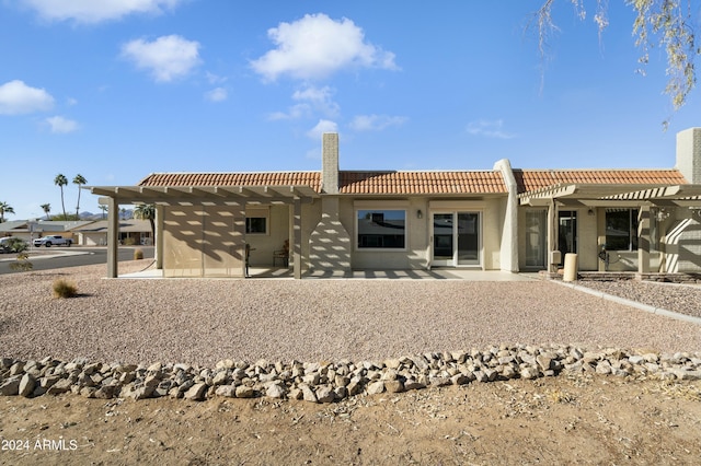 back of property featuring a pergola and a patio area